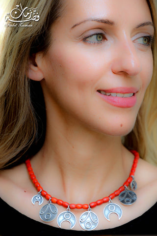 Amulets necklace with coral stones